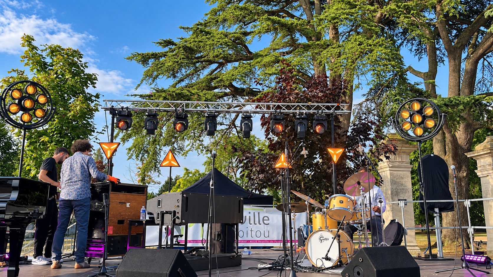 Scène de concert en plein air avec instruments, sonorisation et projecteurs